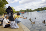 An Arab family feed the birds on the Serpentine Lake in Hyde Park.Arabs have been visiting London for centuries and around 300,000 Arabs have chosen to make the capital their home and a further half a million throughout the UK. The number swells significantly from visitors during the summer. Saudi Arabians spend the most on property in London choosing Belgravia, Kenington, Knightsbridge and Holland Park. Arab culture continues to increase in visibility throughout the capital as integration into this most transient of city's continues.©Peter Dench/Reportage by Getty Images