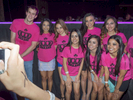 Guests pose for a photograph by the stage at the Twin Peaks 2015 National Bikini Contest where around 68 girls from the USA competed for the crown for Miss Twin Peaks 2015, hosted at Gas Monkey Live, Dallas on the 24th June.Twin Peaks is a chain of sports bars and restaurants (colloquially referred to as breastaurants) based in Dallas, Texas. The chain is known for having its waitresses dress in revealing uniforms that consist of cleavage- and midriff-revealing red plaid (or sometimes black bikini) tops, as well as khaki short shorts. At other times, waitresses wear revealing seasonal or themed outfits. Restaurants are decorated in the theme of a wilderness lodge and serve a mix of American, Southwest and Southern cuisines as well as alcohol. The chain's slogan is {quote}Eats. Drinks. Scenic Views.{quote}Dallas is a major city in Texas and is the largest urban center of the fourth most populous metropolitan area in the United States. The city ranks ninth in the U.S. and third in Texas after Houston and San Antonio. The city's prominence arose from its historical importance as a center for the oil and cotton industries, and its position along numerous railroad lines.For two weeks in the summer of 2015, photographer Peter Dench visited Dallas to document the metroplex in his epic reportage, DENCH DOES DALLAS.Photographed using an Olympus E-M5 Mark II©Peter Dench/Getty Images Reportage