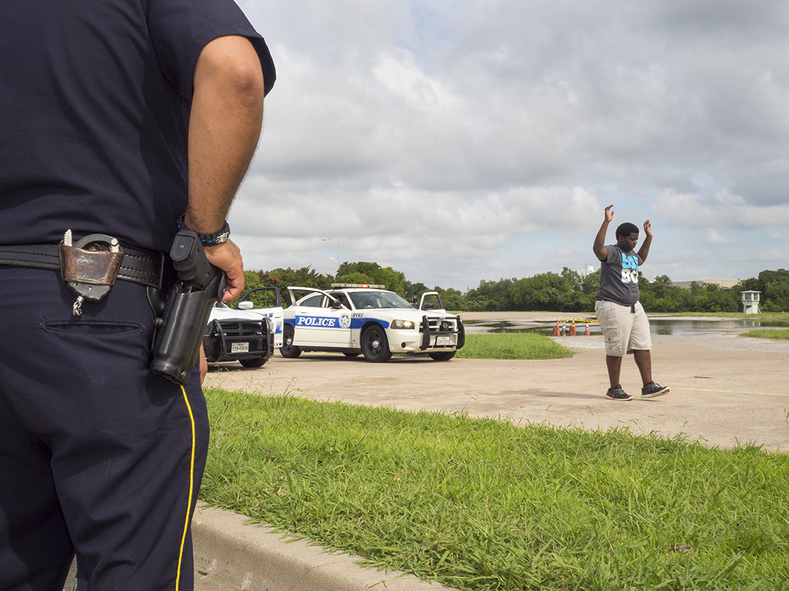 A demonstration of a Felony Traffic Stop by Dallas Police Explorers [DPE]. The DPE program is designed to acquaint young people with the nature and complexity of law enforcement.Dallas is a major city in Texas and is the largest urban center of the fourth most populous metropolitan area in the United States. The city ranks ninth in the U.S. and third in Texas after Houston and San Antonio. The city's prominence arose from its historical importance as a center for the oil and cotton industries, and its position along numerous railroad lines.For two weeks in the summer of 2015, photographer Peter Dench visited Dallas to document the metroplex in his epic reportage, DENCH DOES DALLAS.Photographed using an Olympus E-M5 Mark II©Peter Dench/Getty Images Reportage