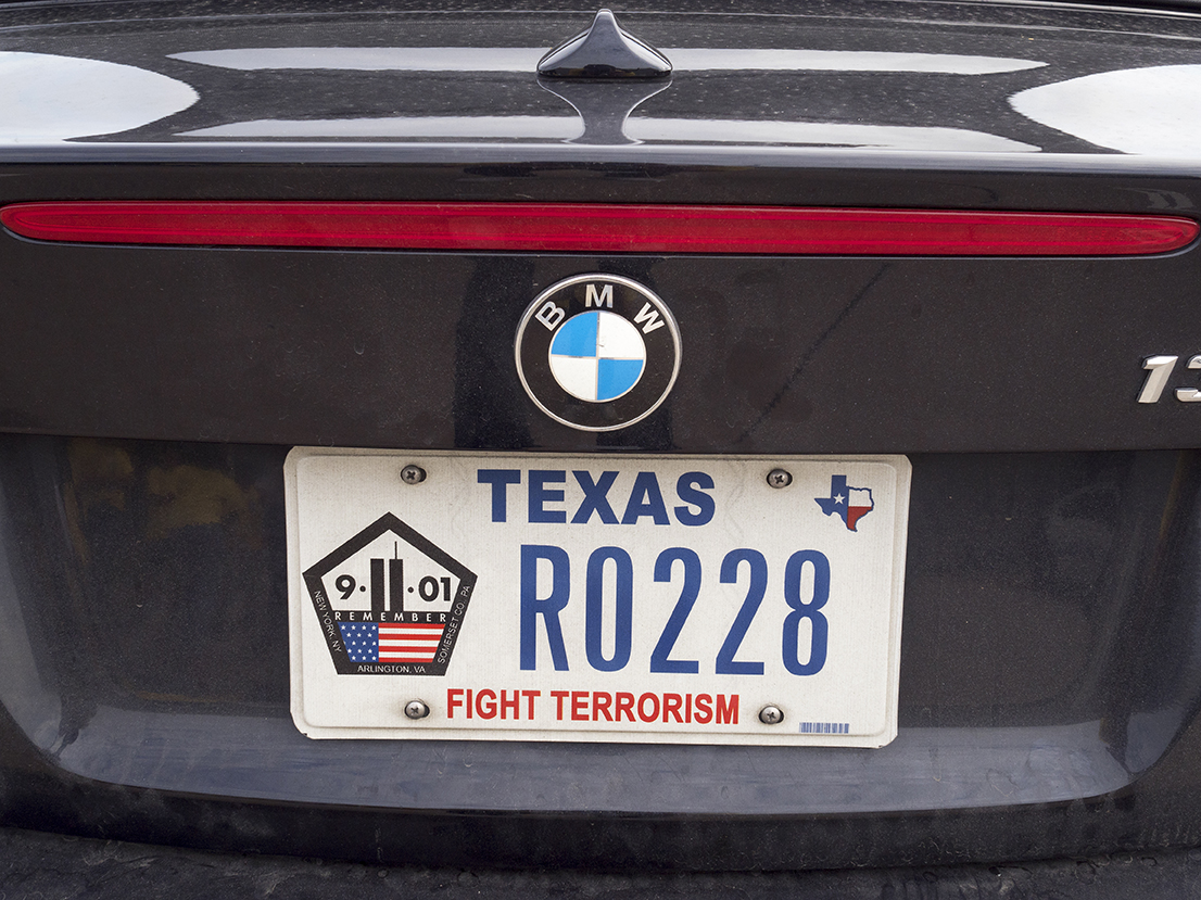 'FIGHT TERRORISM' a message from one motorist.Dallas is a major city in Texas and is the largest urban center of the fourth most populous metropolitan area in the United States. The city ranks ninth in the U.S. and third in Texas after Houston and San Antonio. The city's prominence arose from its historical importance as a center for the oil and cotton industries, and its position along numerous railroad lines.For two weeks in the summer of 2015, photographer Peter Dench visited Dallas to document the metroplex in his epic reportage, DENCH DOES DALLAS.Photographed using an Olympus E-M5 Mark II©Peter Dench/Getty Images Reportage