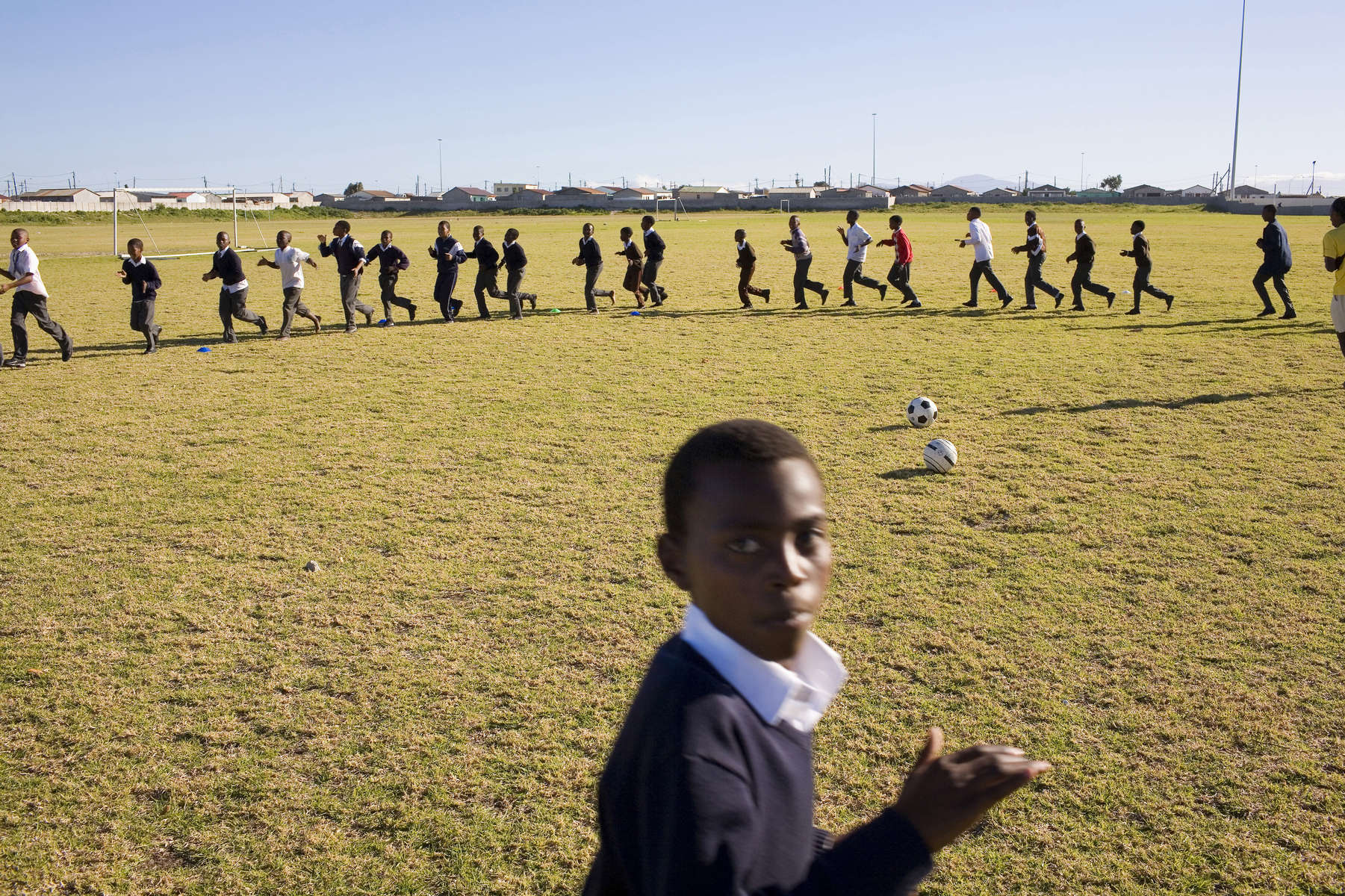 Kids on the Grassroot Soccer programme at a school in Cape Town. The idea is to develop a curriculum for HIV/AIDS education based on games. Football attracts kids and the the message from the game can easily be transferred to life.In disaster areas, war zones and urban wastelands, football keeps humanity alive. It brings nations together and promotes unity. It encourages equality and generates pride and self-belief. It has the power to heal and to help, to motivate, to give freedom to dreams and empower a generation. There are millions of people playing the game or helping it to flourish who find that football brings a positive dimension to their lives.Away from the billionaire owned clubs with it's multi-million dollar players, Football's Hidden Story is a series of emotive human interest photographs showing the positive impact football has had at grassroot level on individuals and communities all around the world. 