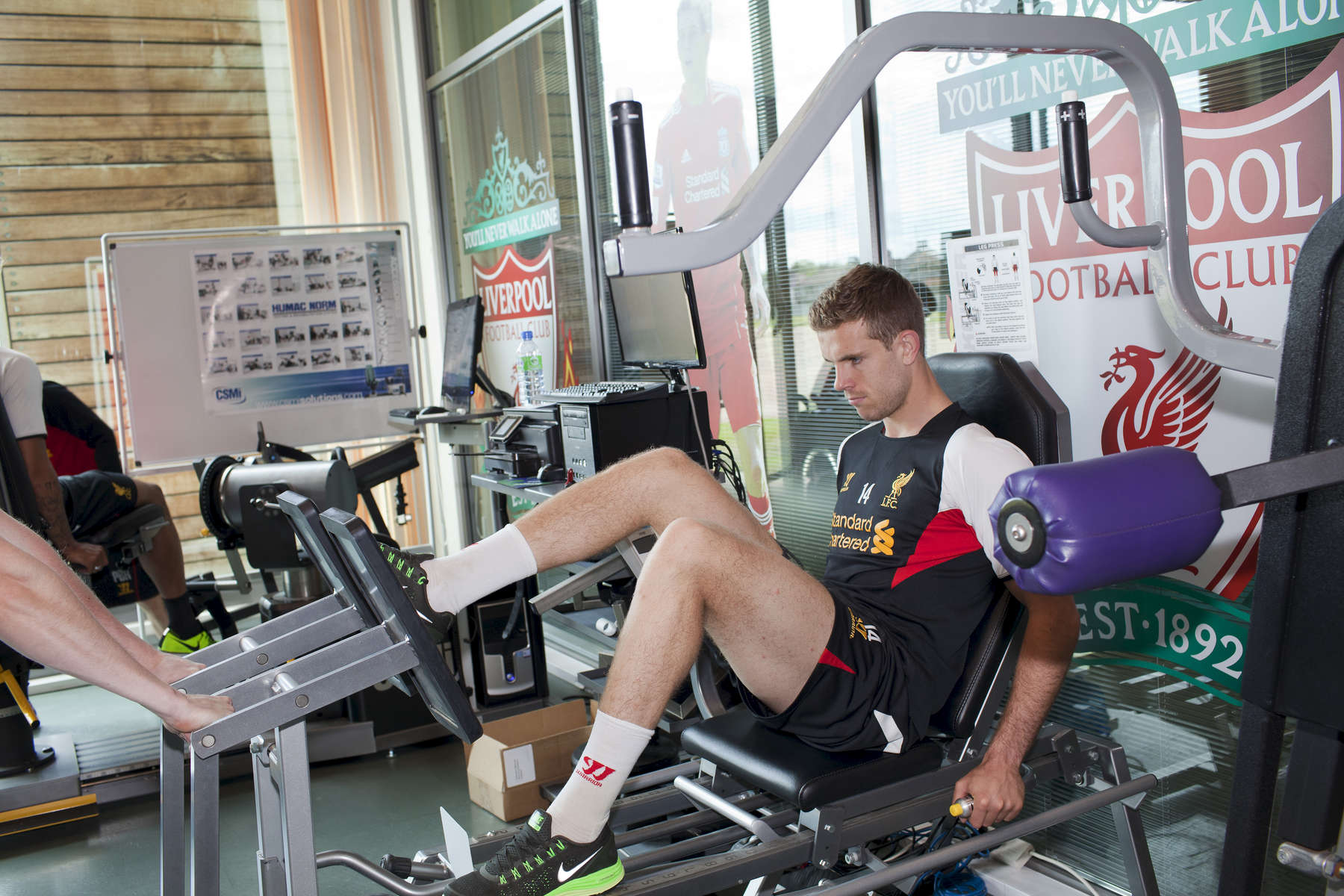 Liverpool FC midfielder Jordan Henderson works out in the gym at Melwood.Melwood is the Liverpool FC training ground, located in the West Derby area of Liverpool. It is seperate from the Liverpool Academy, which is based in Kirkby.Melwood was redeveloped in the early 2000′s with large input from then-manager Gerard Houllier and now features some of the best facilities in Europe. It has been the club’s training ground since the fifties and was previously transformed into a top class facility by Bill Shankly.Facilities include sythetic pitches, rehabilitation rooms, press and meeting rooms, gymnasium, swimming pool, restaurant and recreational facilities.