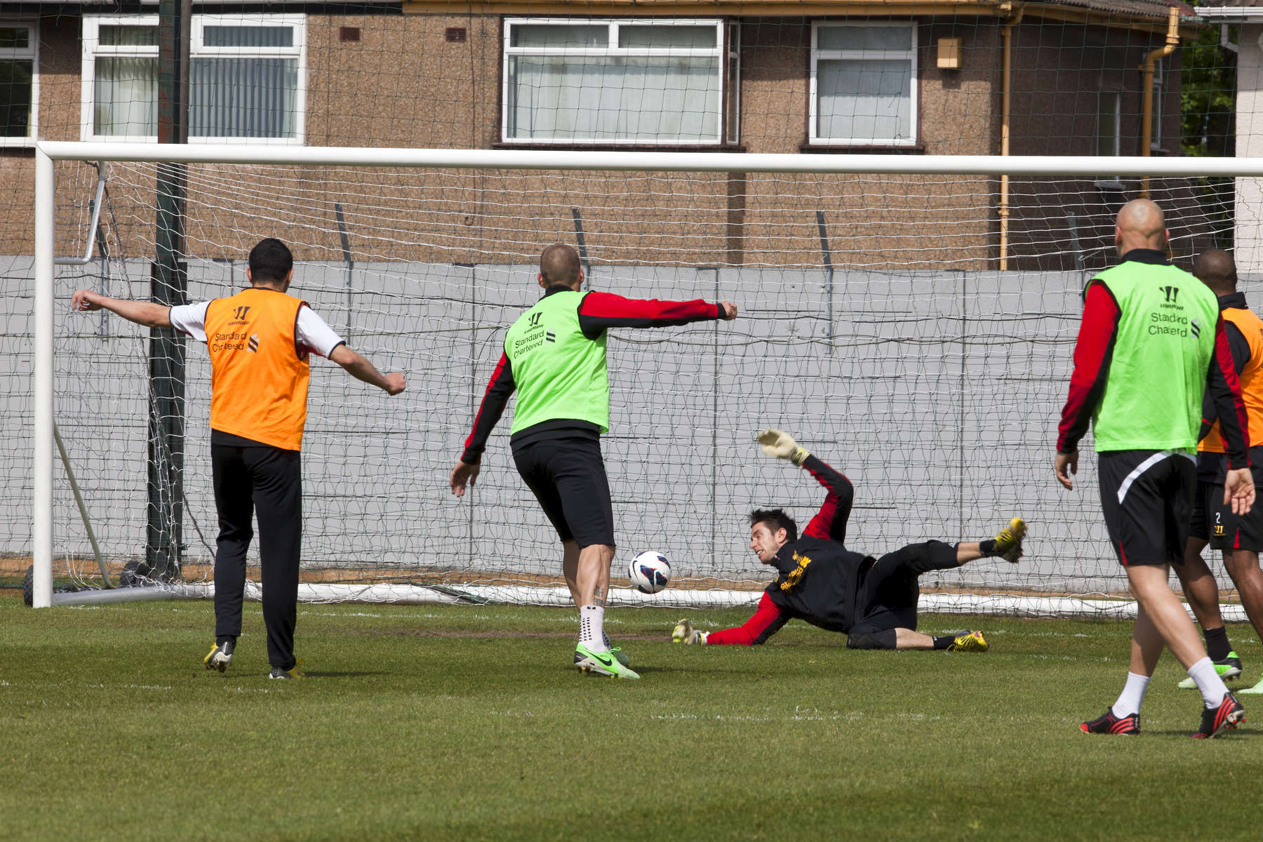 A training goal is scored against Liverpoll FC goalkeeper Brad Jones at the Melwood facility.Melwood is the Liverpool FC training ground, located in the West Derby area of Liverpool. It is seperate from the Liverpool Academy, which is based in Kirkby.Melwood was redeveloped in the early 2000′s with large input from then-manager Gerard Houllier and now features some of the best facilities in Europe. It has been the club’s training ground since the fifties and was previously transformed into a top class facility by Bill Shankly.Facilities include sythetic pitches, rehabilitation rooms, press and meeting rooms, gymnasium, swimming pool, restaurant and recreational facilities.