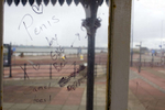 Graffiti penned on the glass of a weather shelter on New Brighton promenade.In 1986, world famous photographer Martin Parr published his book 'The Last Resort,' a set of photographs taken over three seasons 1983-85 in the Liverpool suburb of New Brighton. 25 years later, photographer and Parr fan, Peter Dench, went on a Bank Holiday pilgrimage to New Brigthon to walk in Parr's footsteps and document what has changed or remained the same in the seaside town.