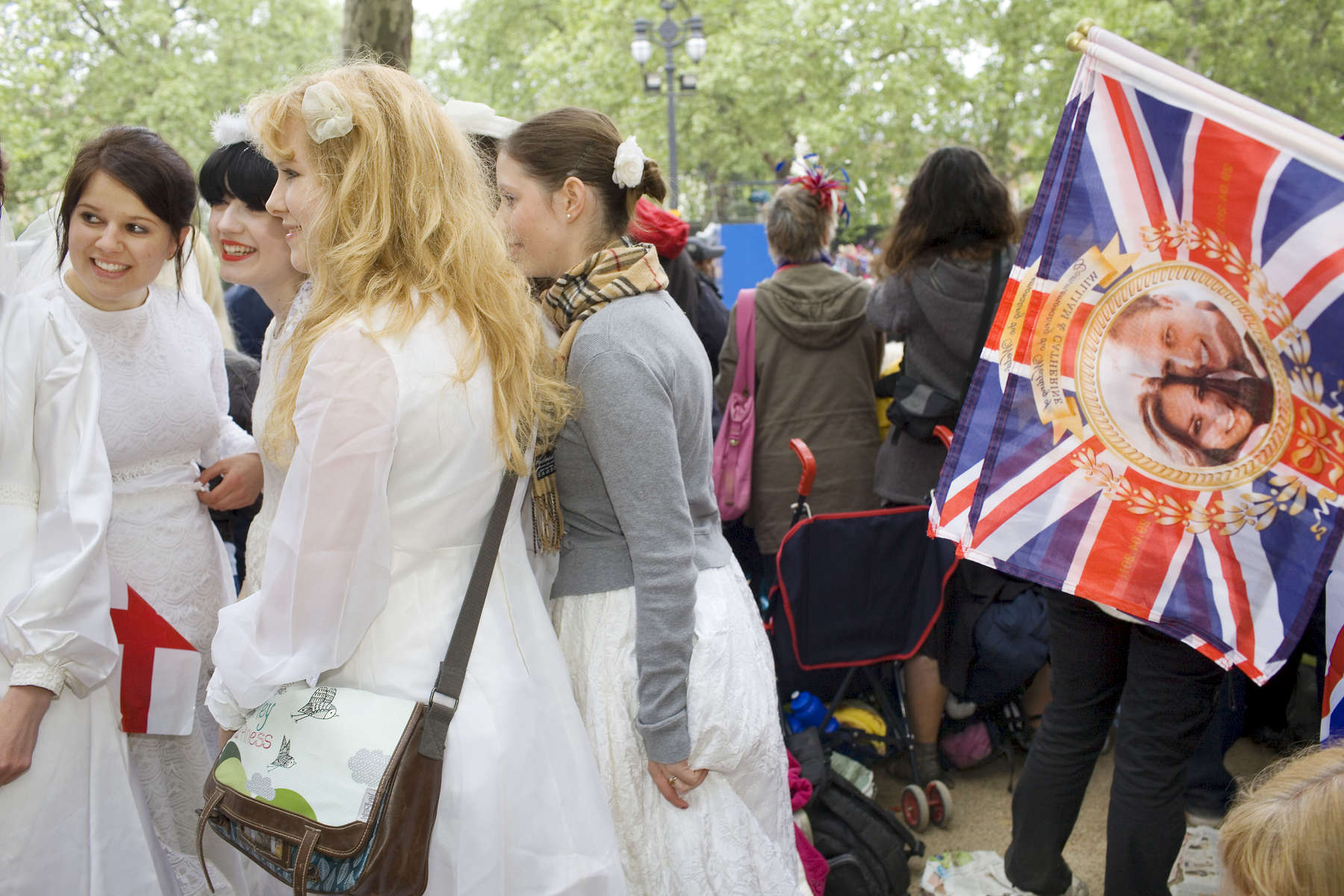 Women dressed as brides wait on the Mall in central London for the Royal Wedding between Prince William and Kate Middleton to begin.