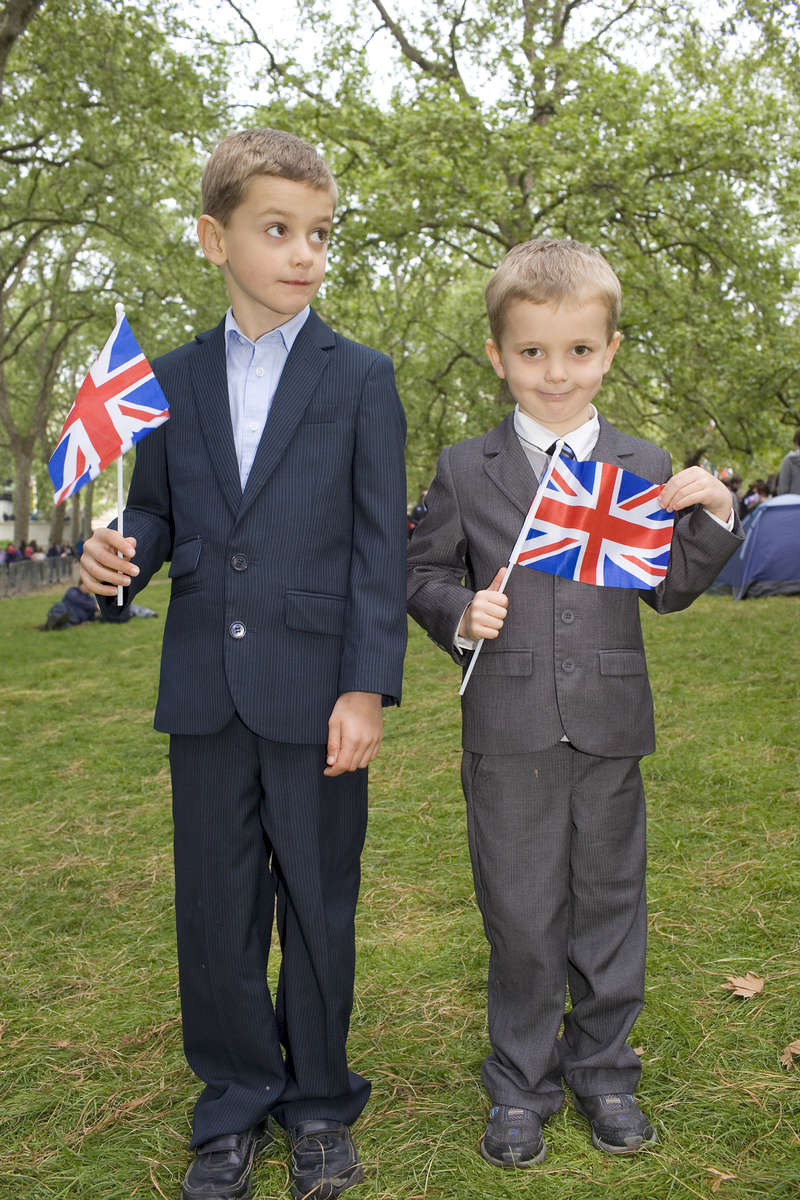 Brothers 8-year old Harry (left) and Rory Arthur, 5, dressed in suits and waving union flags wait for the royal wedding to begin between Prince William and Kate Middleton.
