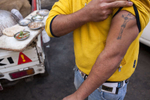 Walid, a young Zabaleen man, shows his tattoo of Jesus Christ on the cross. The Zabaleen are a community of around 25, 000 Coptic Christians living in the Cairo uburb of Moqqatam.Zabaleen, which literally means “garbage collectors” have assumed a semi-official role as Cairo’s binmen. The Zabaleen men usually do two shifts. They leave at about four or five in the morning, and again at about nine. The poorer Zabaleen use donkey carts, but many earn enough to rent trucks. They then take the garbage back to their homes for the women to pick through for items to recycle.