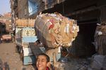A Zabaleen man loads a truck with cardboard for recycling in Moqqatam.Moqqatam is a suburb on the edge of Cairo and home to a people known as the Zabaleen, said to be the world’s greatest waste recyclers. The Zabaleen, which means plainly enough, “the garbage collectors”, pick up around 4,000 tons of Cairo’s waste each day. American researchers have shown that the Zabaleen recycle 85% of this garbage into something useful: a higher rate than anywhere else on the planet. The men do two shifts leaving about 4am and again around 9am. The rubbish is taken back to Moqqatam for the women to sit in and sort through. The organic waste is fed to livestock (the Zabaleen are originally swine herders), the rest sorted for recycling. The future of the Zabaleen is uncertain: if the Cairo authorities get their way, this community of around 25,000 Coptic Christians living in a Muslim country will be gone, and with it, their unique lifestyle.