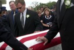 Millie Maggard, wife of a slain Air Force sergeant, follows the casket with her daughter before her husband's funeral. 