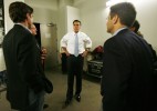 Republican presidential candidate Mitt Romney speaks with campaign advisors after the Massachusetts primary.
