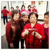 At 83, Chan Kwai Ken, known as Mrs. Eng (pictured in front, left) comes to the Mulberry Street Senior Center twice a week to attend the singing and dancing group she founded 15 years ago. A former kindergarten teacher in her native Guangzhou, she found work in Chinatown’s laundry and restaurant business, and retired when her health began to fail. Sitting at home idly left her feeling depressed: “I used to love playing the piano, and singing and dancing with the children, and I wanted to do something for the community. So I thought, this is what I’m good at.” The Mulberry Street senior center is run by the Chinese-American Planning Council, a community-based organization dating back to the mid-1960s era of the War on Poverty and the unprecedented growth of NYC's Chinese community after the 1965 immigration reform. Located in the heart of historic Chinatown, across from Columbus Park, it serves 500 Chinese-speaking seniors daily. Over the years, Mrs. Eng’s group has grown from its initial 12 participants to over 50 members, mostly women. She can no longer move as easily and her eyesight is faltering, so she has turned over the leadership to someone younger – although she still likes to keep an eye on things and loves to sing the old folk songs. {quote}My body is disabled, but my heart is not. I am happy when I’m here.{quote}