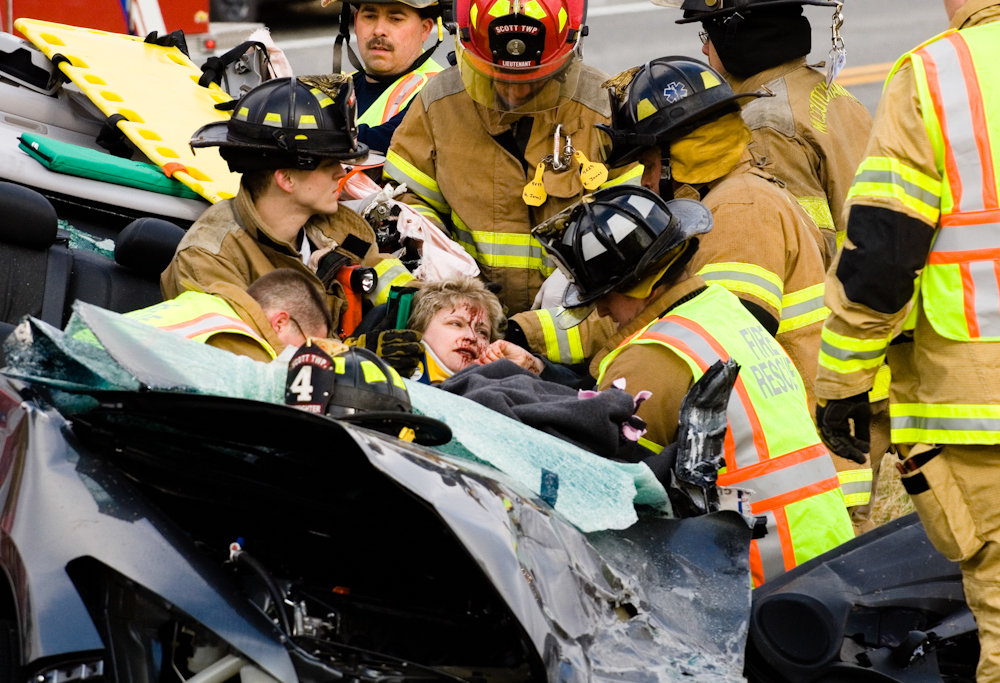 Firefighters work to extricate Janet Sipes, center, from her Honda Accord after a head-on collision with a Ford Ranger on Indiana 57 in northeastern Vanderburgh County on Thursday, January 8, 2009.  Both Sipes and Matthew Ackerman, the driver of the Ford Ranger, were taken by ambulance to St. Mary's Medical Center for treatment.