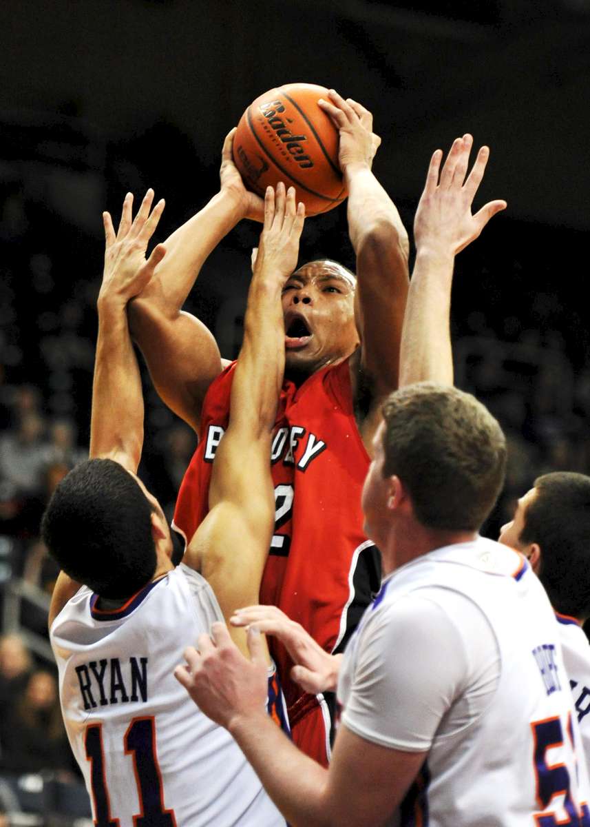 MOLLY BARTELS / Courier & PressBradley University sophomore, Dyricus Simms-Edwards, shoots past University of Evansville defenders during the first half of the game at Roberts Stadium in Evansville on Sunday, January 23, 2011. Evansville won 70-67.