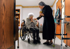 Bea Belcher receives communion from Sister Carolyn Martin recently at St. John’s Home for the Aged, which is run by Little Sisters of the Poor, in Evansville. Belcher, who started in the independent living apartments in 1987, has been at the facility for 25 years. “They’ve always been so good to me here,” she said. Last spring the Little Sisters announced that they planned to withdraw from operating the home once they found a suitable sponsor to take over. They are still searching and continue to seek financial donations for the home.