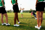 Lillie Price, 5, takes a swing while members of North High School's girls golf team look on during a golf clinic at Eagle Valley Golf Club in Evansville on Wednesday, July 20, 2011.  The clinic encourages girls to start playing golf at an early age which helps feed North's high school program. Price's older sister, Olivia, 16, not pictured, plays for North.