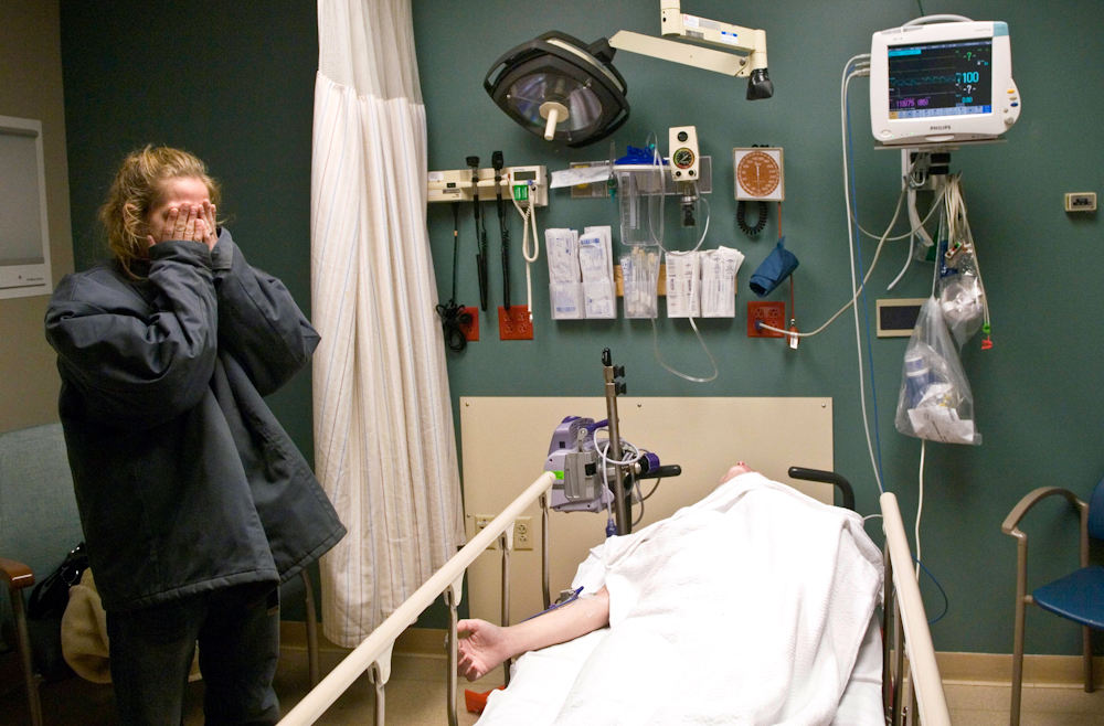 Natasha Hedges, left, is overwhelmed after she and friend, Heather Houston, center, were in a car accident on Wednesday, December 23, 2009. Hedges waits with Houston who was waiting for treatment at St. Mary's Medical Center in Evansville.