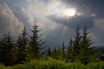 Sunbeams slice the sky as clouds roll out of the valley near Waterrock Knob on the Blue Ridge Parkway