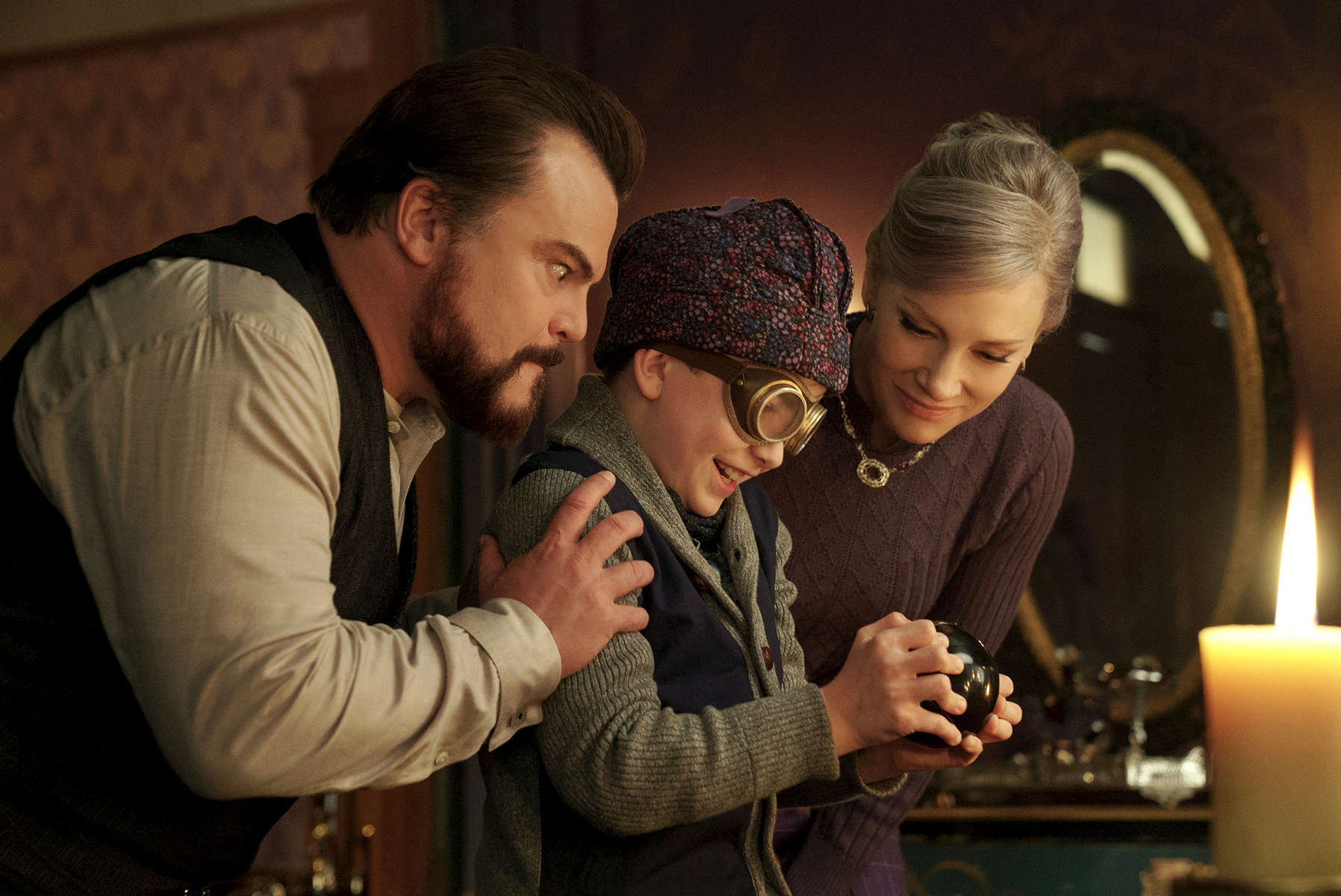 (L to R) JACK BLACK, OWEN VACCARO and CATE BLANCHETT star in The House with a Clock in Its Walls, from Amblin Entertainment.  The magical adventure tells the spine-tingling tale of 10-year-old Lewis (Vaccaro) who goes to live with his uncle (Black) in a creaky old house with a mysterious tick-tocking heart.  But his new town’s sleepy façade jolts to life with a secret world of warlocks and witches when Lewis accidentally awakens the dead.