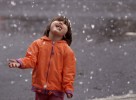 Two-year-old Baylie Herbert of Marysville gets a taste of her first snow during a rare snowstorm in downtown Marysville.