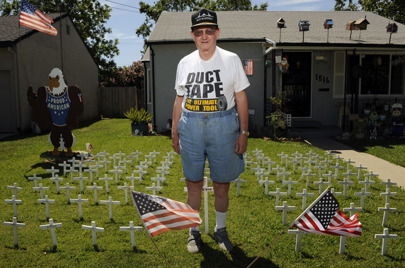 Retired Air Force Tech. Sgt. Jerry Kester makes and displays crosses on his lawn in memory of those lost in conflict.
