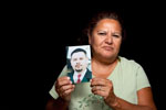 Elsa Sandoval holds a picture of her late son Joey Sandoval. Joey was shot and killed outside their home March 29, 2003 in Salinas.