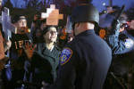 Protestors confront Santa Rosa police officers across from the police department along Sonoma Avenue while protesting the death of Andy Lopez in Santa Rosa on Tuesday, December 10, 2013. (Conner Jay/The Press Democrat) 