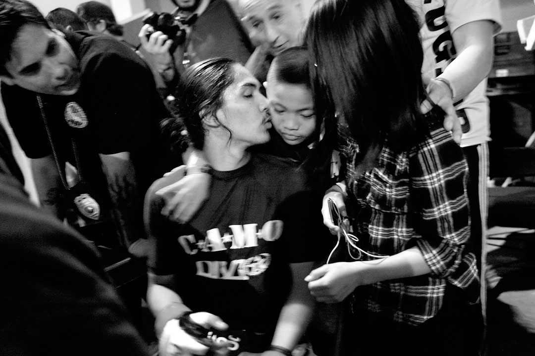 Jonathon Gaxiola kisses his younger brother after winning his debut cage fight at the Central Coast Throwdown's {quote}Winter Brawl{quote} in Salinas. Gaxiola said training as a fighter gives him potentially dangerous tools, but that training has also helped him develop discipline and responsibility. “This sport is a really good way to get away from [the gang] lifestyle,” said Gaxiola, who was exposed to gangs growing up in the area. “This teaches you the mental game. It shows you how to have that mental toughness to overcome those pressures.”