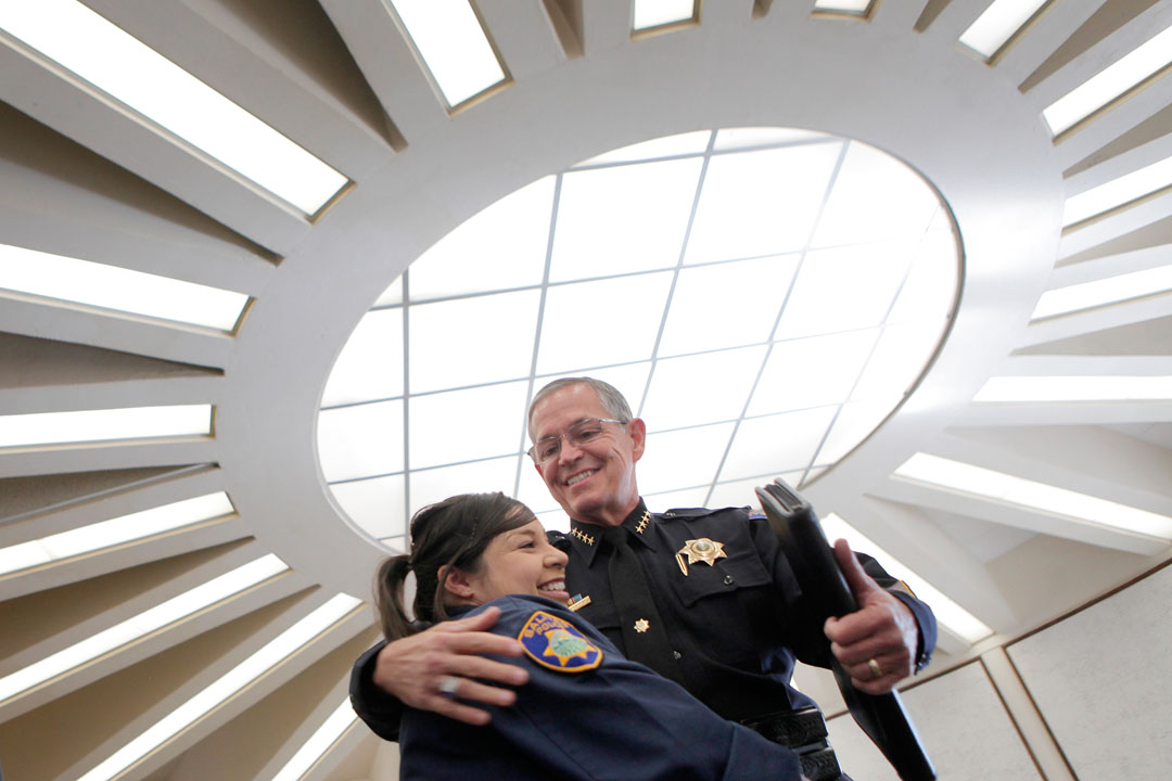 Salinas Police Chief Louis Fetherolf, right, embraces evidence technician Jessy Pacheco after announcing his retirement Wednesday at Salinas City Hall. About three months after going out on medical leave, Chief Fetherolf announced he would be leaving his position due to of his health. 