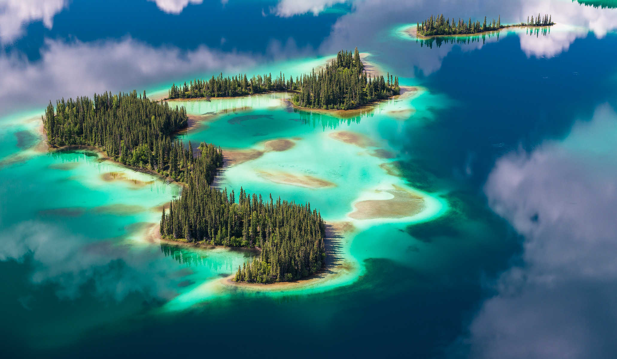 I came across this remarkable scene on a recent assignment covering a large area in the extreme north of British Columbia. The aquamarine colour of this lake is the result of light reflected from the silt and shell fragments which compose the bottom of the lake.    Spanning the northern Rockies, the proposed Kaska Indigenous Protected and Conserved Area would preserve 40,000 square kilometres in the core Ancestral Territory of the Kaska Dena in far north of British Columbia, protecting the land while sustaining existing jobs and creating new jobs in conservation economy/tourism opportunities. In July of 2020 I extensively flew and photographed this remarkable and diverse landscape and had the wonderful opportunity of 30 hours of helicopter time to explore this vast area.                       Fine Art Prints                                            Prints are limited to an edition of 50 each in size 8” X 10” and 12” x 18”. Prints sized 16” x 24” and 20” x 30” and 24” x 36” are limited to 25 each, 30” x  45” prints are limited to 15 prints and 40” x 60” prints are limited to 10 prints.    Please contact garth@garthlenz.com for additional information, to discuss pricing or to assist in your selection.Fine Art Print Price List8” X 10”$20012” X 18”$45016” X 24”$65020” X 30”$100024” X 36” $1500 30” X 45”$230040 X 60” $3600Prices are for prints only and do not include framing, shipping, or tax. Please contact garth@garthlenz.com to order. Prints are usually shipped within 5 working days.