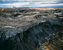 Tar Sands pit mining is done in benches or steps. These benches are each approximately 12-15 meters high. Giant shovels dig the tar sand and place it into heavy hauler trucks that range in size from 240 tons to the largest trucks, which have a 400-ton capacity.