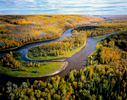 Located just east of Fort McMurray, Alberta, the intact Clearwater River shown here, soon joins the Athabasca River as it winds its way north through the Tar Sands, bordered by the vast, unlined, leaching tailings ponds which border it on either side. Forests like this are tranformed into tar mines to access the {quote}bitumen{quote} buried under them.