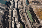 At the edge of an 80-meter deep mine, a massive tar sands truck is dwarfed by the surrounding landscape. These 400-ton trucks are the world’s largest measuring 25 feet high, 47 ½ feet long, and 32 feet wide. The mines, machinery, and trucks of the Alberta Tar Sands were the inspiration for Avatar’s Edmonton-born art director’s vision of the mining operation on Pandora.