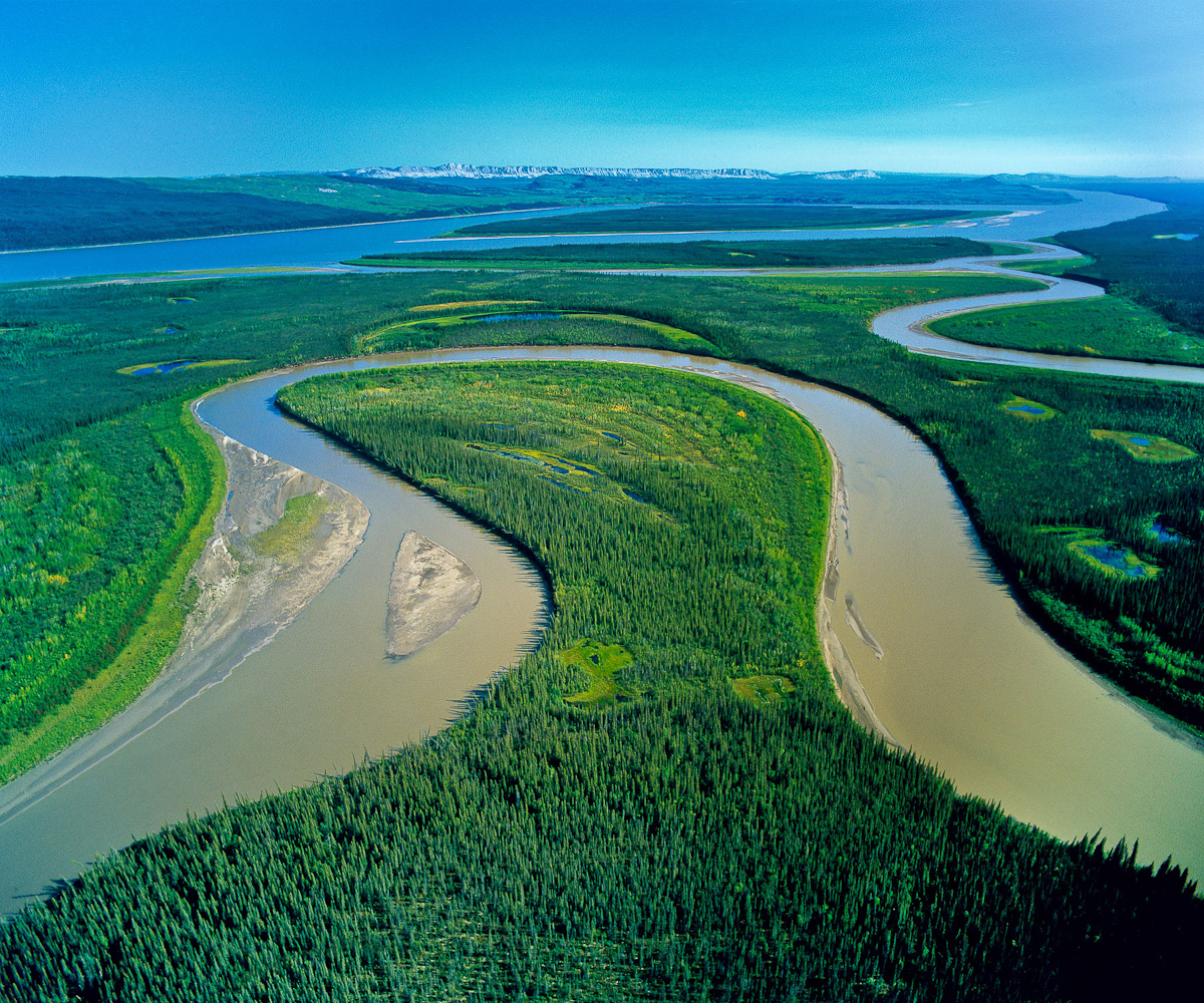 The Caracajou River winds back and forth creating this oxbow of wetlands as it winds it way to join the Mackenzie flowing north to the Beaufort Sea.    This region, almost entirely pristine, and the third largest watershed basin in the World, is the setting for the proposed Mackenzie Valley National Gas Pipeline to fuel the energy needs of the Alberta Oil Sands mega-project.Exhibition print:  35{quote}x45{quote} archival pigment print on Hahnemuhle bamboo, bonded to aluminum.