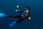 I love incorporating fruit into dive shots.  Here Jaye takes a close look at an orange that is hovering mid-water.