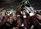December 31, 2013 - Mississippi State Bulldogs celebrate their 44-7 victory over the Rice Owls as they hoist the 55th annual AutoZone Liberty Bowl trophy. (Mike Brown/The Commercial Appeal)
