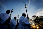 March 27, 2016 - As the sun rises Rick Martin (from left), Matthew Sorg and Bubba McArthur wait to lead the procession of the gifts of bread and wine to the alter during the 31st annual Easter Sunrise Mass at Calvary Cemetery. Hundreds of faithful filled folding chairs and camp seat, some bundled under blankets the celebrate Easter with the rising sun.(Mike Brown/The Commercial Appeal)