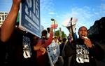 April 14, 2016 - Christopher Smith (right) leads chants during a protest outside the McDonald's on Union seeking higher wages for fast food workers. Some of the roughly 60 protesters gathered stormed the restaurant and chanted by the registers before briefly blocking traffic on Union. (Mike Brown/The Commercial Appeal)