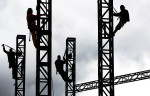 May 6, 2013 - (from left) Ronnie Harris, Carlin Tally, Austin Scott and David Morgan work together to remove the towers on one of the stages used during the Memphis in May Beale Street Music Festival to get preparations underway in the park for the 36th annual World Championship Barbecue Cooking Contest starting May 16. (Mike Brown/The Commercial Appeal)