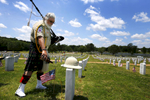 May 30, 2016 - Retired Army Col. Darwin Concon pours out a beer on the grave of his best friend he enlisted into the Army with in August 1978. Concon, who went on to serve a combat tour in Iraq during his 33 year career in the Army, played his bagpipes for his friend, Norman Shannon.  (Mike Brown/The Commercial Appeal)