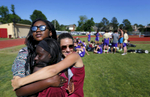 April 27, 2016 - St. George's senior Erica Stevenson (back) and sophomore Whitney Ziegenhorn (right) embrace sophomore Christiana Nyarko during a track meet after school at Evangelical Christian School. {quote}In middle school, I felt like it was a lot easier. The issues we are dealing with now in high school, in general, we didn't notice back then, like race issues.{quote} Stevenson said. {quote}It just became more apparent. The high school years were harder than the middle school years.{quote} (Mike Brown/The Commercial Appeal)