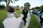 May 6, 2016 - Zearius Jenkins holds Alex Carlton's dress as he picks her up to take her to the Southwind High School prom. After years of going to school together the two became such good friends that they think of each other as siblings. Cartlon was among the original 16 students that crossed over from the St. George's Memphis campus to the Collierville campus but was forced to leave the school after her scholarship was not renewed following the eighth grade. {quote}[St. George's graduates] have more opportunity.{quote} she said. {quote}Southwind doesn't provide as great an opportunity for college. (Mike Brown/The Commercial Appeal)