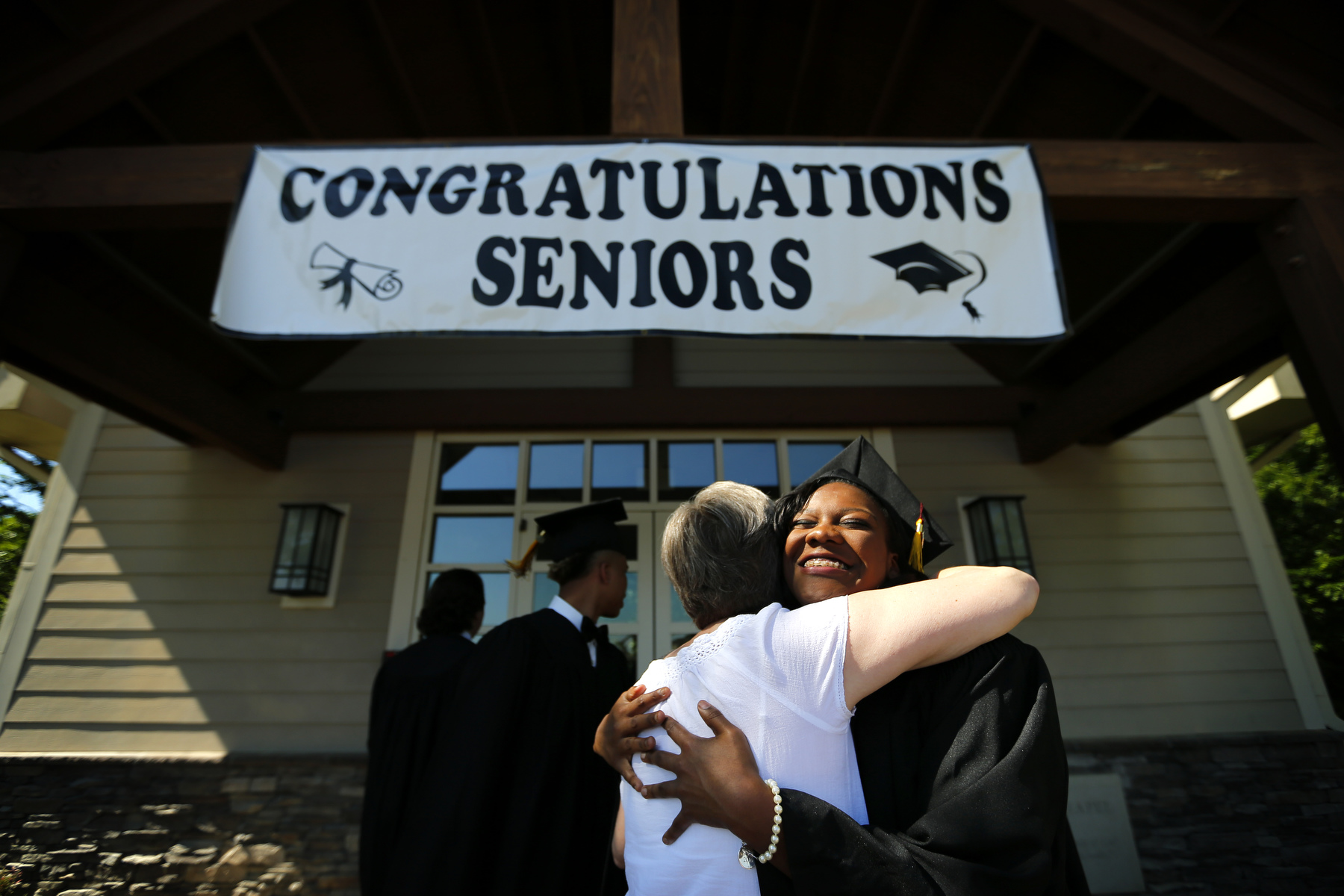 May 22, 2016 - Autumn Jones embraces St. George's former dean of students Jill Reilly shortly before graduation on the St. George's Collierville campus. Reilly, who spent 11 years at the school, began forging a relationship with the students  through regular visits to the Memphis campus beginning in third grade before they made the transition to Collierville in the sixth grade where she taught math. {quote}She was like one of our mothers.{quote} Jones said. {quote}She had high expectation and made sure we knew what we could do and were capable of.{quote} (Mike Brown/The Commercial Appeal)