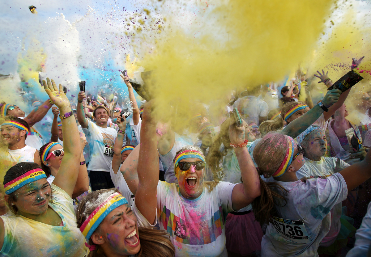 September 7, 2014 - Participants revel in the colored powered being  they are throwing on each other after completing The Color Run at Tiger Lane on Sunday. (Mike Brown/The Commercial Appeal)