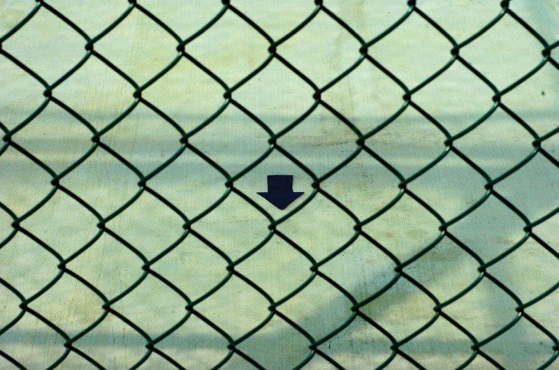 An arrow points towards Mecca inside a recreation yard within Delta Camp 5 on the United States Naval Station in Guantanamo Bay, Cuba. There are similar arrows located all over the facility and within each cell. Military officials said there are five calls to prayer each day, but none were heard or witnessed.(© Mike Brown)