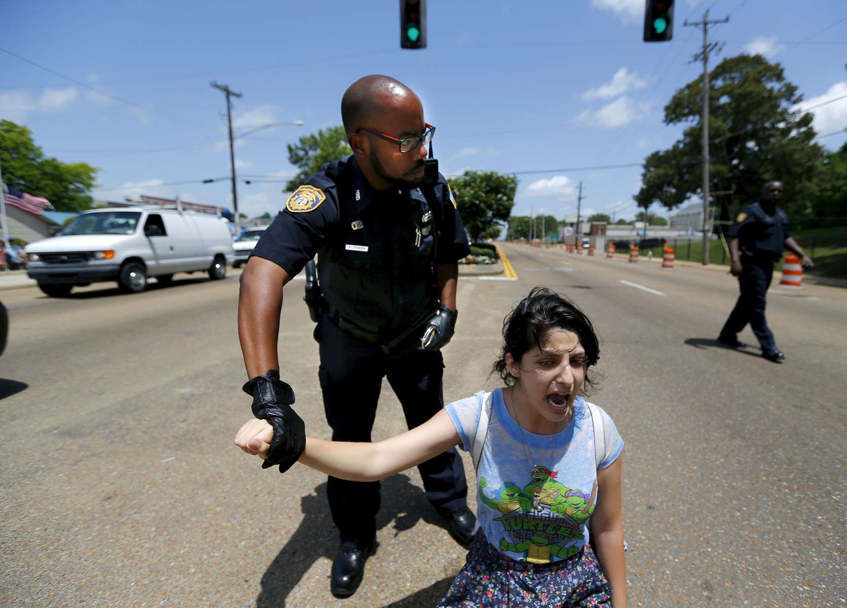 July 12, 2016 - Tamam Quran is handcuffed and detained by police during a Black Lives Matter rally outside Graceland on Elvis Presley Blvd Tuesday afternoon. Roughly 60-70 people gathered peacefully outside the gates of the famous tourist destination. (Mike Brown/The Commercial Appeal)