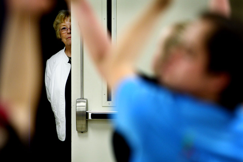 Nancy Thielemier peeks in from behind a hallway while her son, Kenny Thielemier, 23, practices with Company d at Hope Presbyterian Church. Nancy and her husband Ken have worked since Kenny's birth to help him be independent. “The best advice we got was to not put any kind of limit on what he could or couldn’t do,” she said.