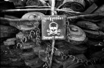 A bin full of disarmed land mines serves as a constant reminder of the dangers that await Cambodians in the forests and fields throughout the country. Even with heavy demining activities in the country there is still an estimated 8-10 million land mines silently awaiting their victims.(© Mike Brown)