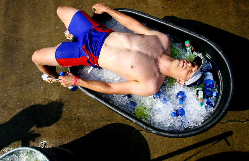 Professional triathlete Andrew Starykowicz, from Long Grove, IL, collapses into a tub of iced down drinks to cool off after completing the annual Memphis in May Triathlon at Edmund Orgill Park in Millington.(Mike Brown/Memphis Commercial Appeal)