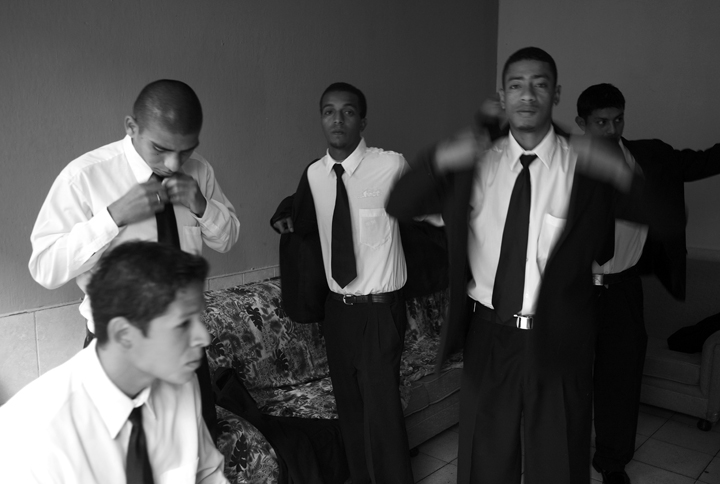 Several young men, who are related by family, prepare to work as camalenque.