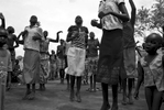 Young South Sudanese refugees, who fled their country because of war, entertain themselves with a dance called {quote}Daluka.{quote} Once a week they don their best clothing and gather for this social event; however, some of the children, such as the child on the right, have very few clothing items. In response to fighting which broke out in South Sudan in December 2013, thousands of South Sudanese refugees crossed the border at Nimule into northern Uganda. The fighting was between forces loyal to South Sudan president Salvar Kiir and his ex-vice president Rick Machar. The refugees have refused to return to South Sudan because of fear the fighting will resume. 